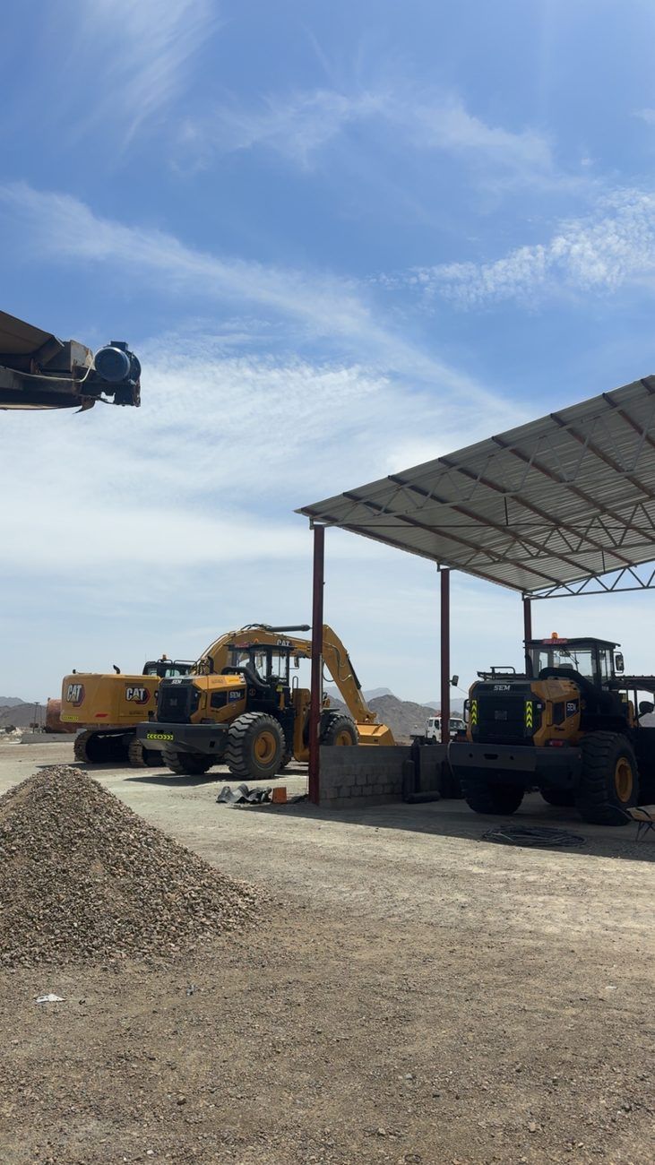 Hafeet Crushers equipment yard — CAT excavator and SEM loaders
